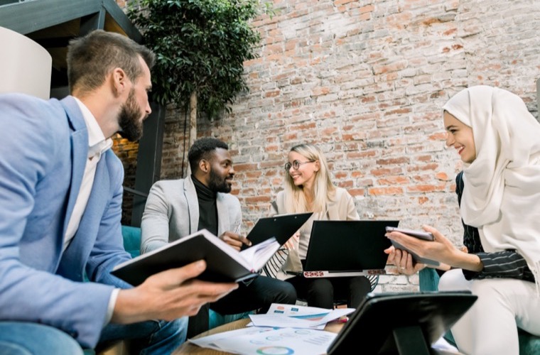 A real estate professional collaborating with a team of advisors around a table